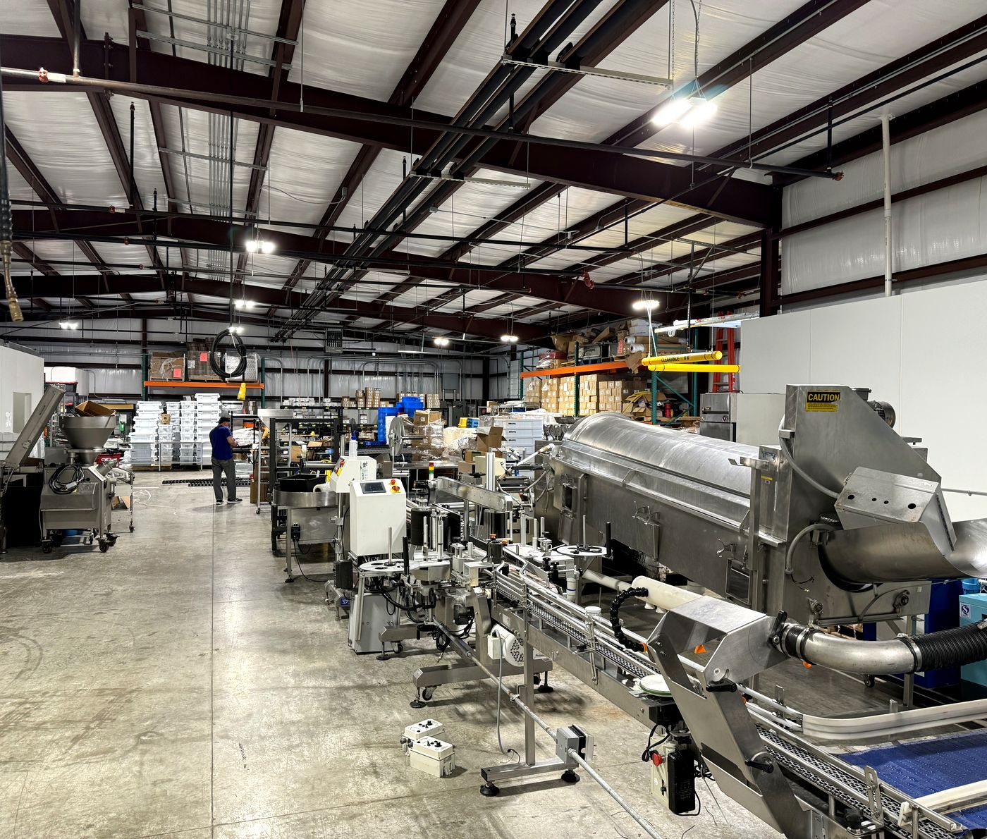 The production line at the Spud House bakery in Georgetown, Texas, with an operator working mid-floor